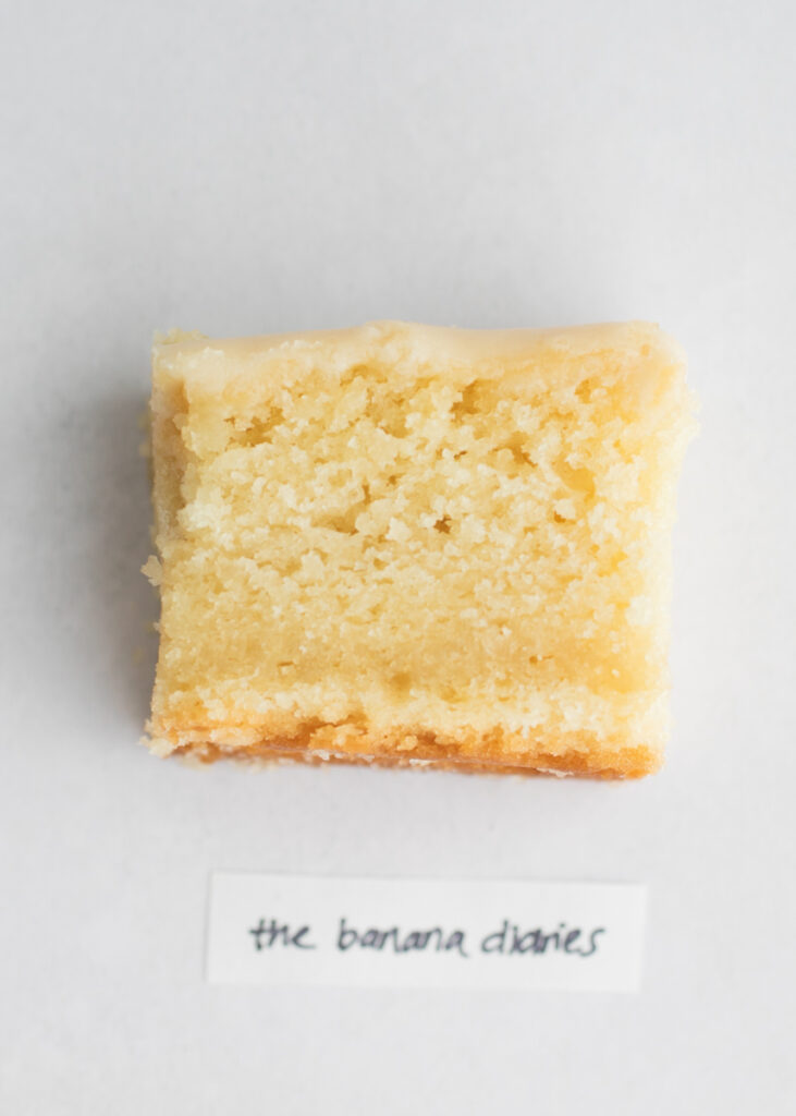A slice of vegan vanilla cake with a label that says "The Banana Diaries."