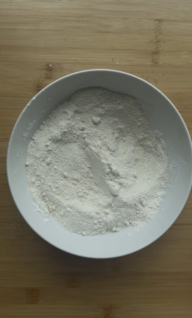 A white bowl full of dry ingredients.